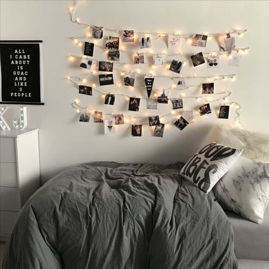a dorm room decorated with photos and lights
