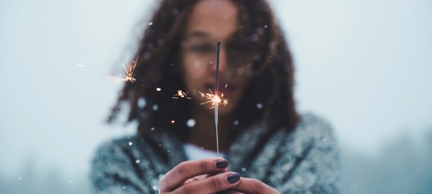 a girl holding a sparkler in her hands