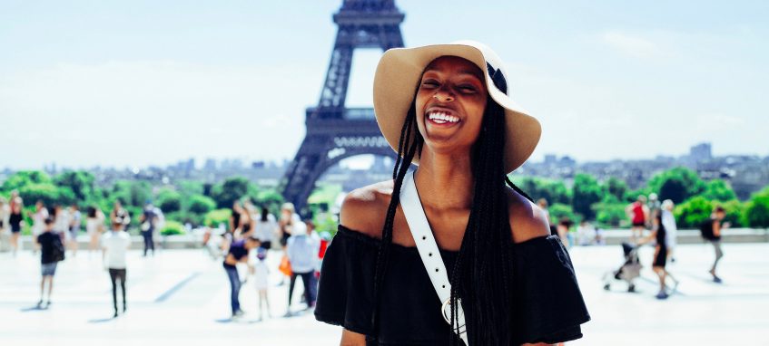 a girl laughing near the Effeil Tower