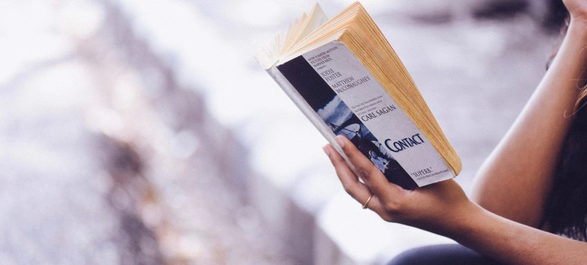 a girl reads a book about self-discipline