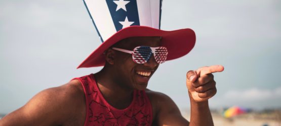 a guy in uncle Sams hat is pointing at someone and laughing
