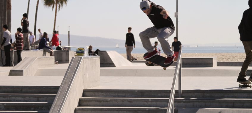 a guy is learning to ollie on skateboard downstairs