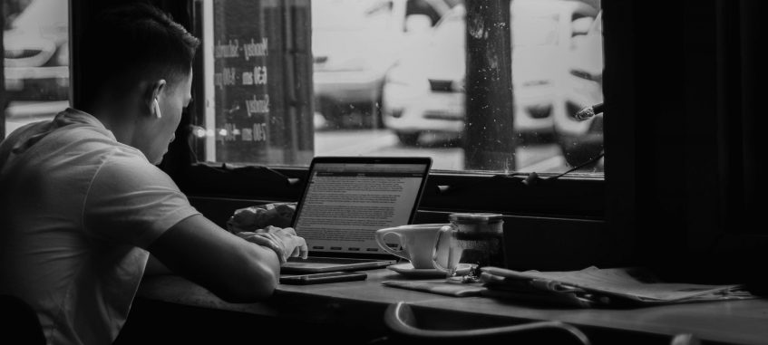 a guy studying hard at a coffee house