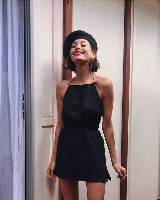 a little black dress and a black hat on a young girl