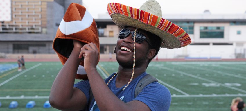 a man wearing sombrero on the background of football field
