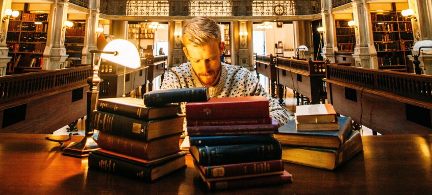 a student reading at the desk in the library at night