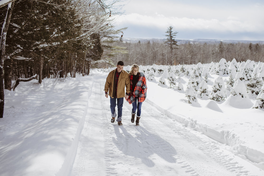 a young couple strolling along the snowy street