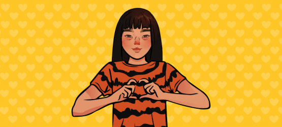a girl in a tiger shirt shows a heart with her hands