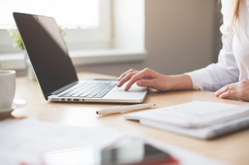 woman typing laptop on the desk