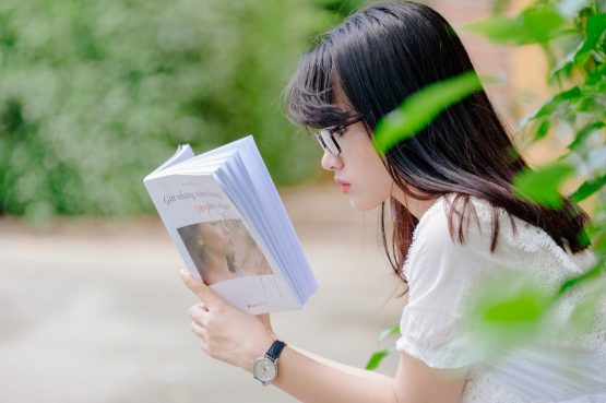 asian girl reading a book