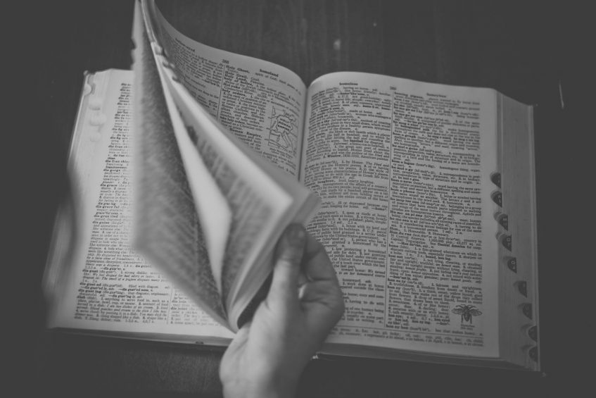 girl flipping a big dictionary