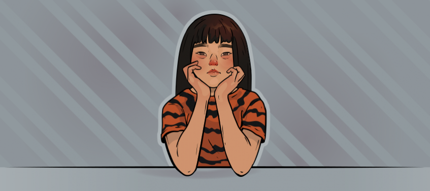 a girl in a tiger shirt is sitting confused and upset