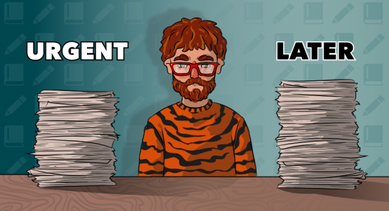 a guy in a tiger sweater is sitting between two piles of assignments