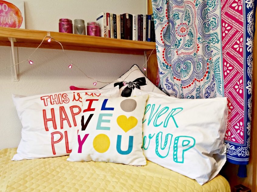 colorful pillows placed on dorm bed