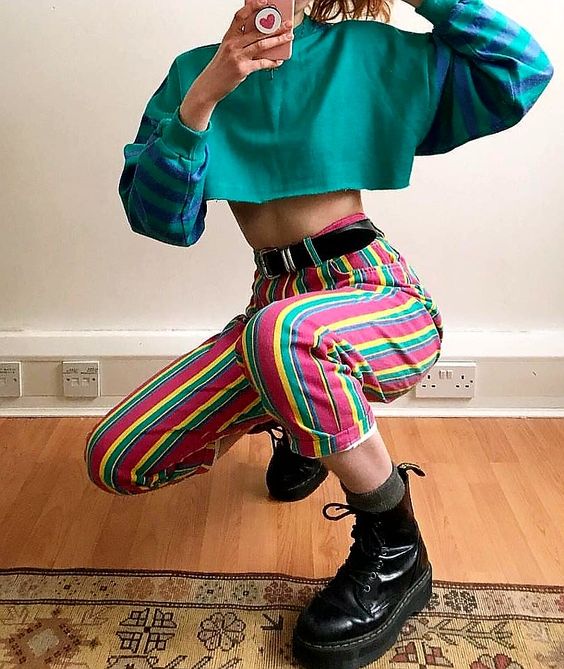 colorful vertical-striped pants and a bright long-sleeved top on a girl