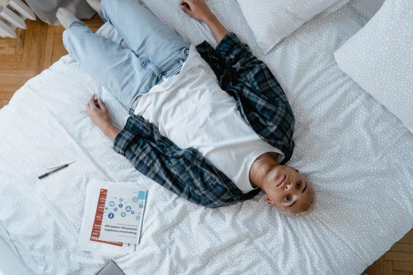 dissapointed student lying on bed