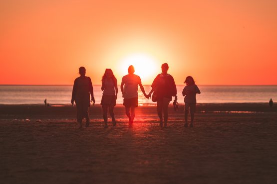 family on the beach at sunset