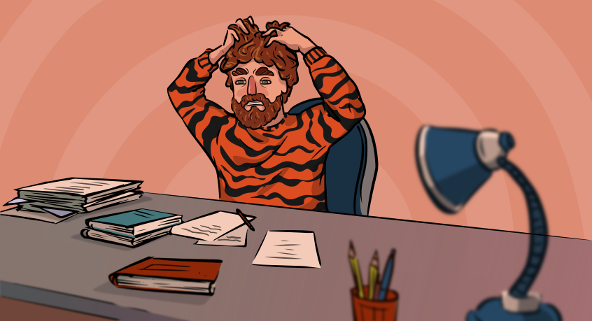 guy in a tiger sweater is sitting at his desk stressed about his homework