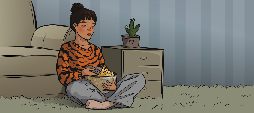 the girl in a tiger sweater is sitting with popcorn and a remote in hands