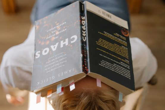 a girl with a book over her face