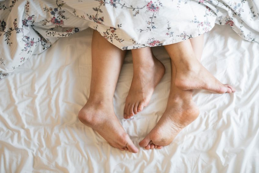 his and hers feets under the duvet