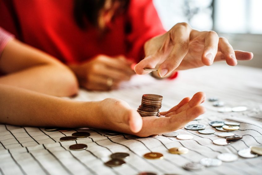 two hands with coins