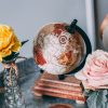 a globe and roses on the table