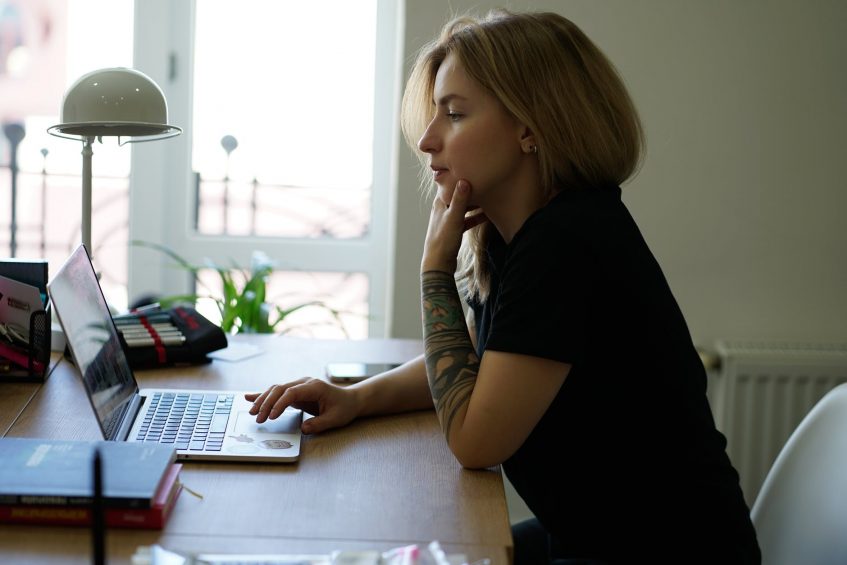 a girl sitting with a laptop