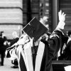 a graduation student waves at someone
