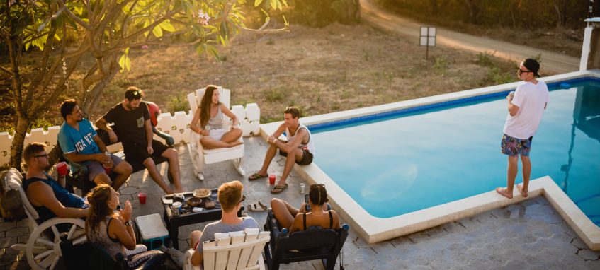 college students drinking at the swimming pool