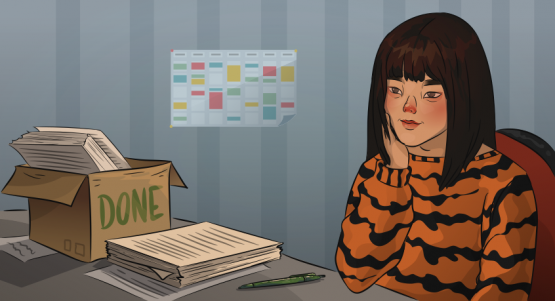 a girl in a tiger sweater is sitting at the desk
