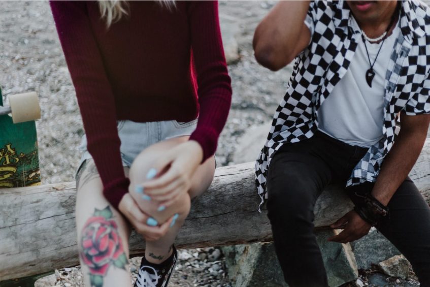 a guy and a girl are sitting at the bench together