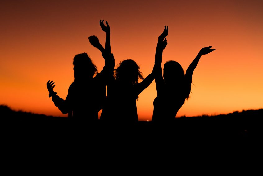 silhouettes of young people dancing