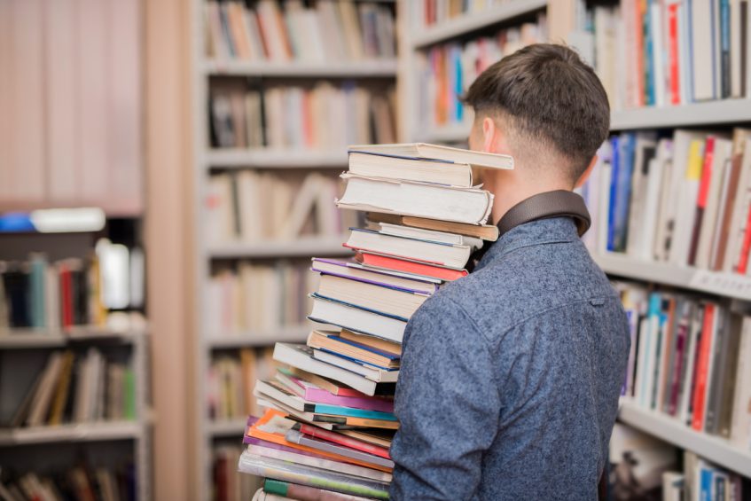 Student holding SAT books