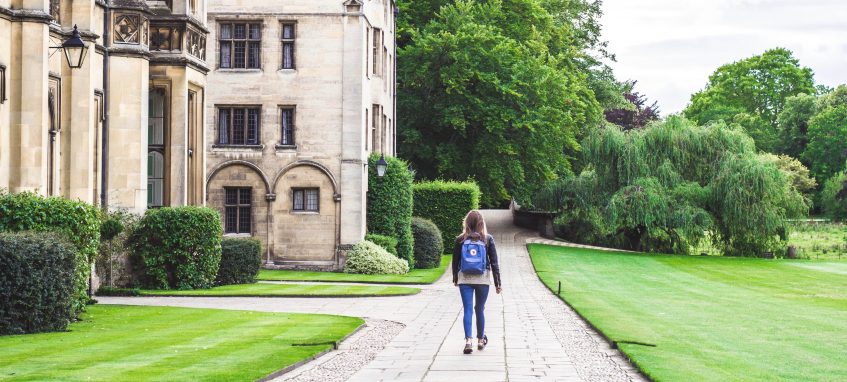 student with a backpack near the university