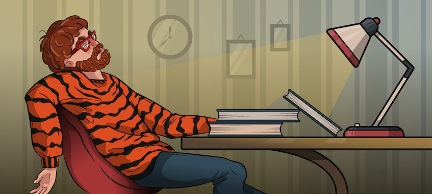 guy in a tiger sweater is sitting at the desk tired