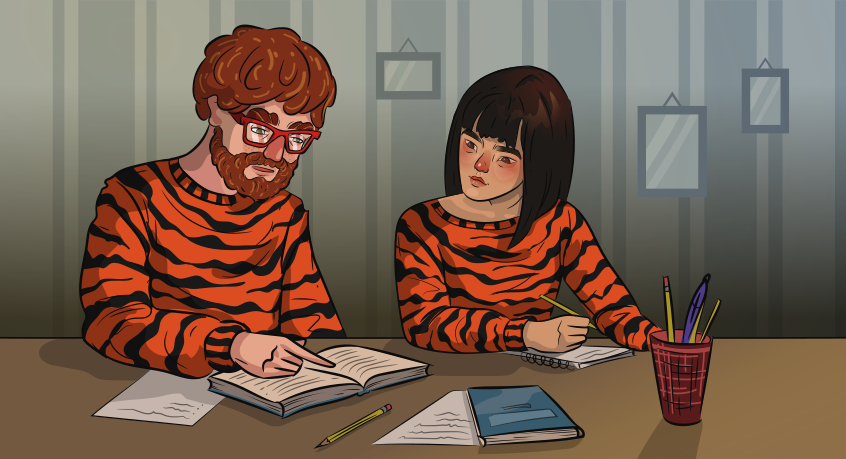 a girl and a guy in tiger sweaters are doing homework together
