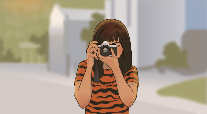 a girl in a tiger shirt is holding a camera