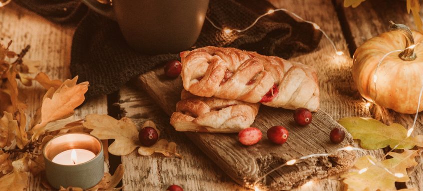 thanksgiving pie, a candle and dry yellow leaves